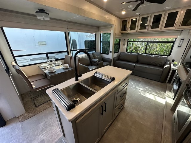 Open-plan kitchen and dining area inside a Rapid Rehouse fifth wheel unit