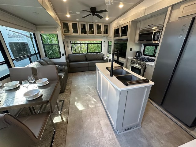Kitchen island and lounge area inside a fifth wheel accommodation unit