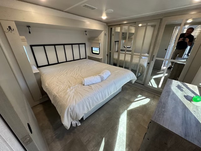 Spacious king size bedroom with sliding mirror wardrobe